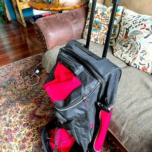 Large rolling duffel bag with retractable handle for travel. New. Black & red.